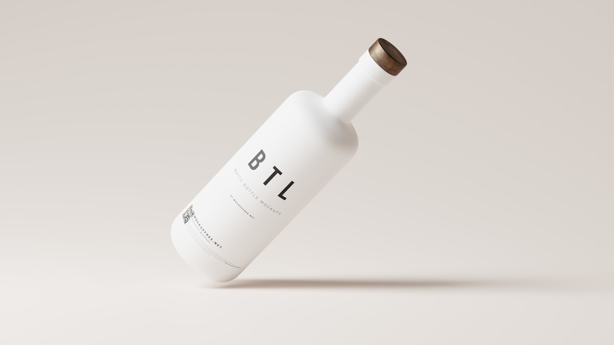 A bottle of olive oil catching kitchen light