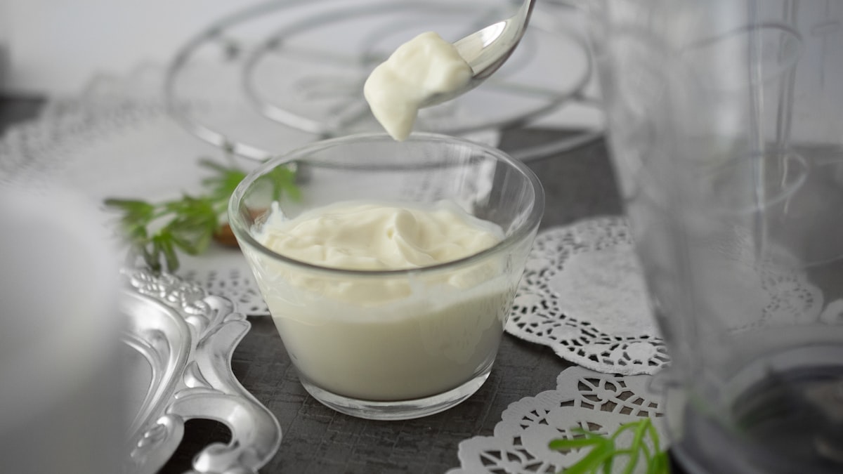 Olive oil, eggs, and mayonnaise ingredients arranged together