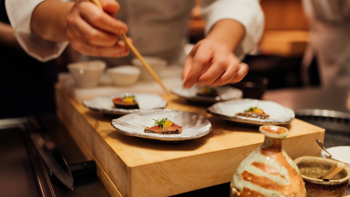 A washoku table setting with a small pour of olive oil alongside traditional Japanese tableware