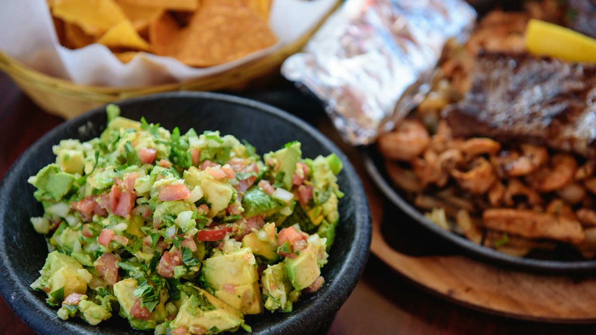 Drizzling olive oil over guacamole