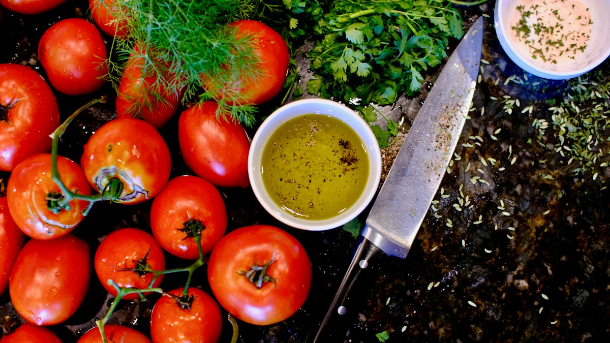 Ingredients for olive oil and vinegar dressing laid out on a surface
